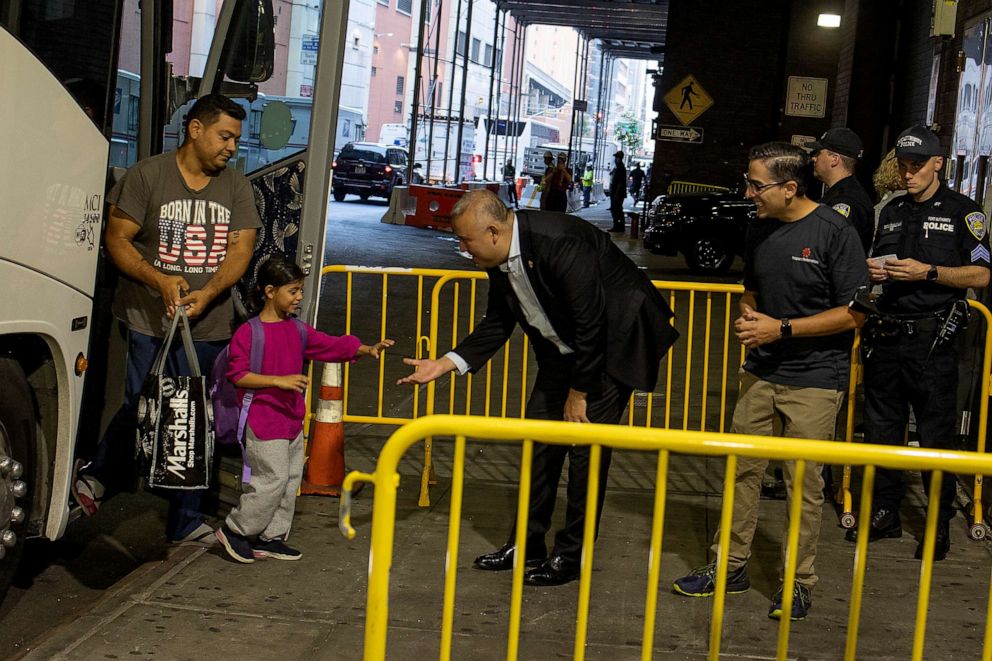 PHOTO: City officials greet migrants arriving on buses from Texas, on Aug. 29, 2022, at the Port Authority bus station in New York.