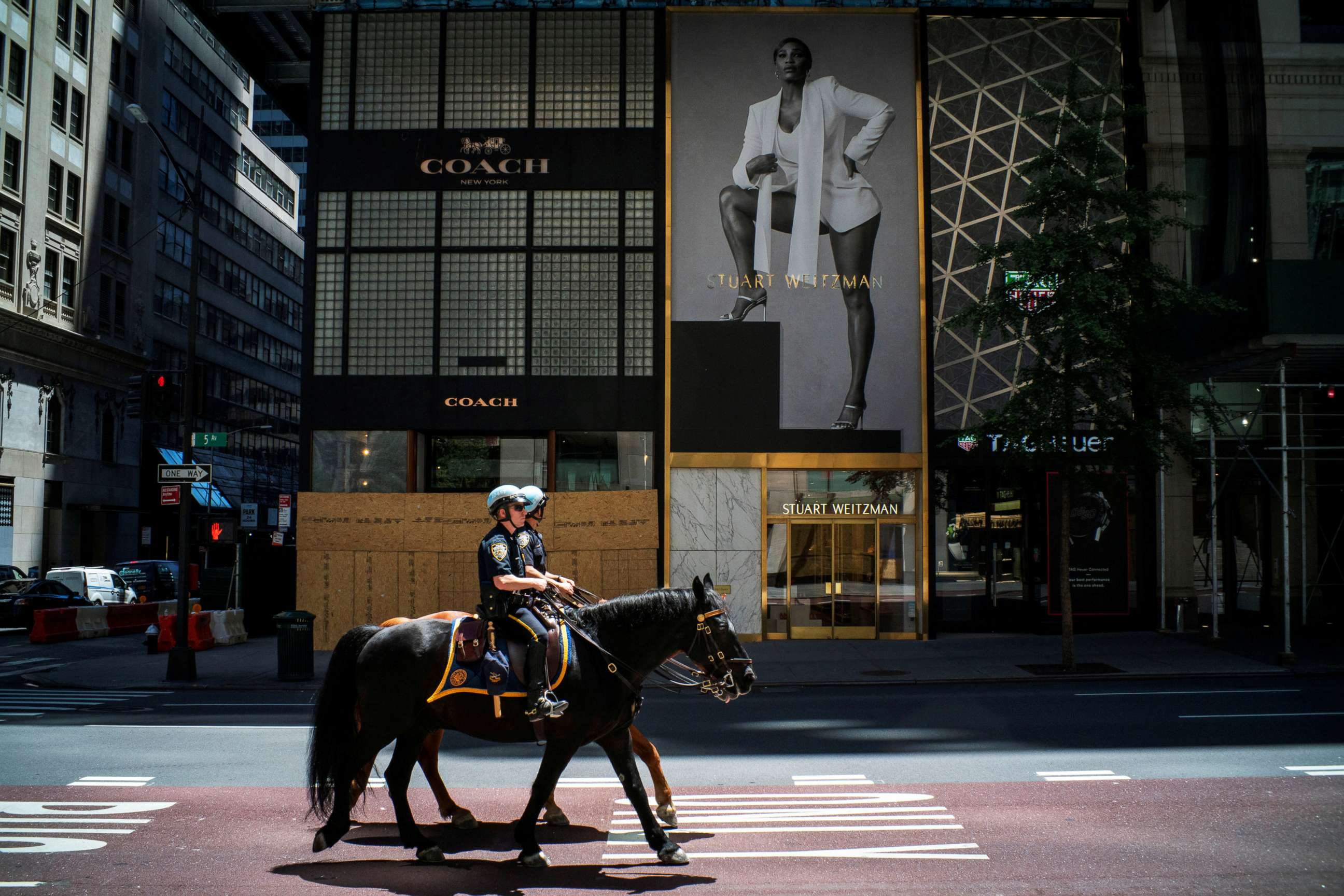 PHOTO: NYPD officers ride horses down 5th Avenue as phase one of reopening after lockdown begins, during the outbreak of the coronavirus disease, in New York, June 12, 2020.