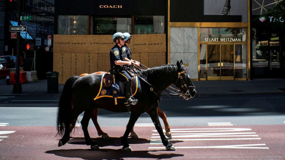 PHOTO: NYPD officers ride horses down 5th Avenue as phase one of reopening after lockdown begins, during the outbreak of the coronavirus disease, in New York, June 12, 2020.