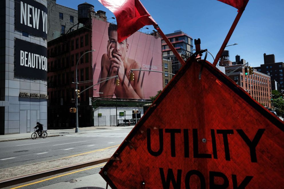 PHOTO: People walk through a central shopping district as stores prepare for gradually reopening in the coming weeks on June 16, 2020, in New York.