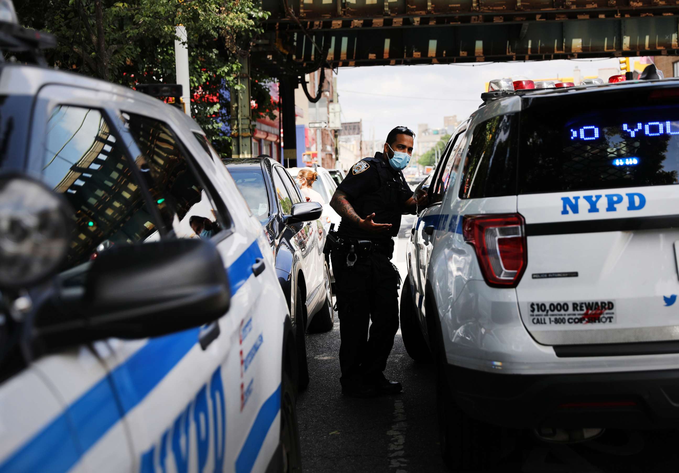 PHOTO: Police speak at the scene of an afternoon shooting that left one person dead on July 07, 2020, in the Brooklyn borough of New York.