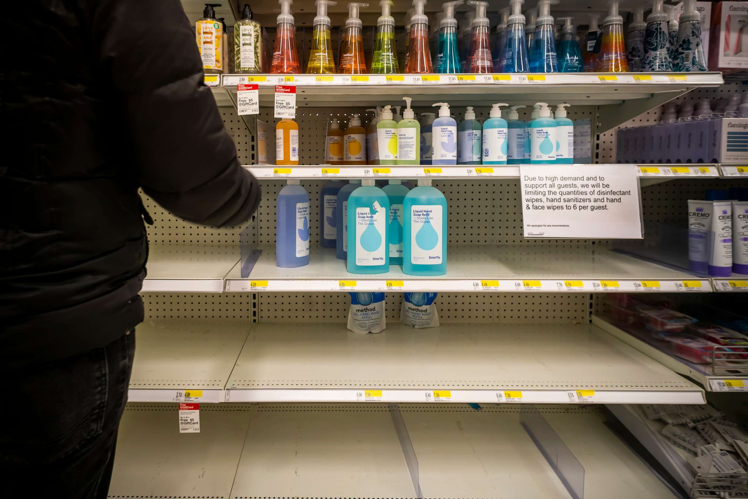 PHOTO: A sign on the empty hand sanitizer shelves of a Target store in New York on March 9, 2020, informs customers of their limit of six bottles per guest.