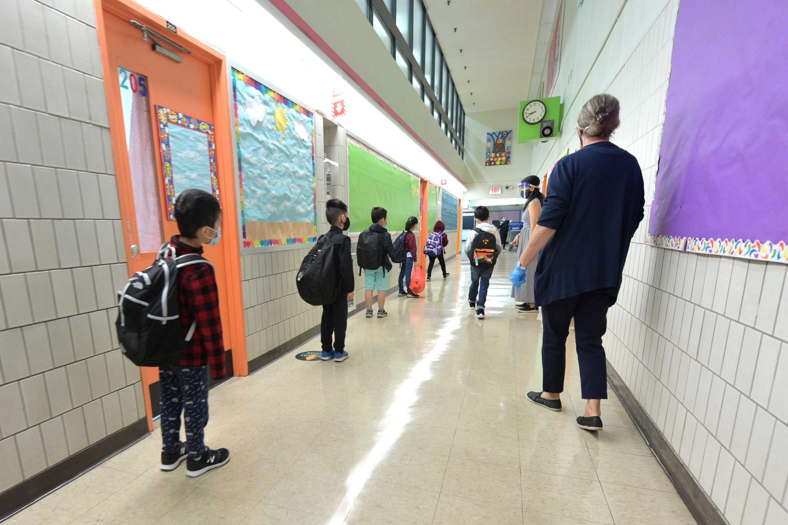 PHOTO: Students line up before walking into class on a day of in person at Yung Wing School P.S. 124,  Oct. 1, 2020, in New York City.