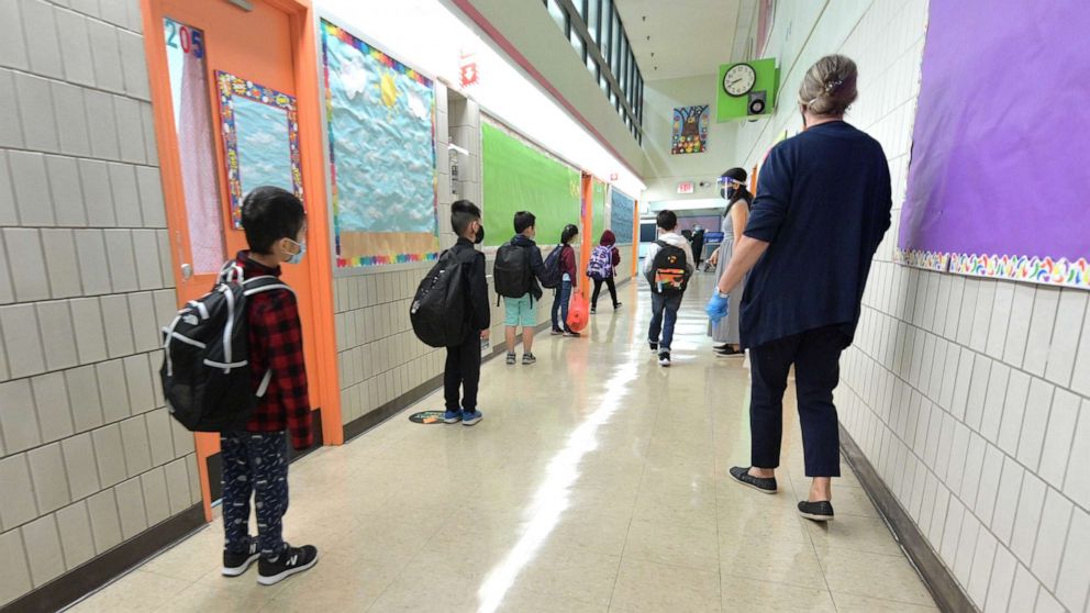 PHOTO: Students line up before walking into class on a day of in person at Yung Wing School P.S. 124,  Oct. 1, 2020, in New York City.