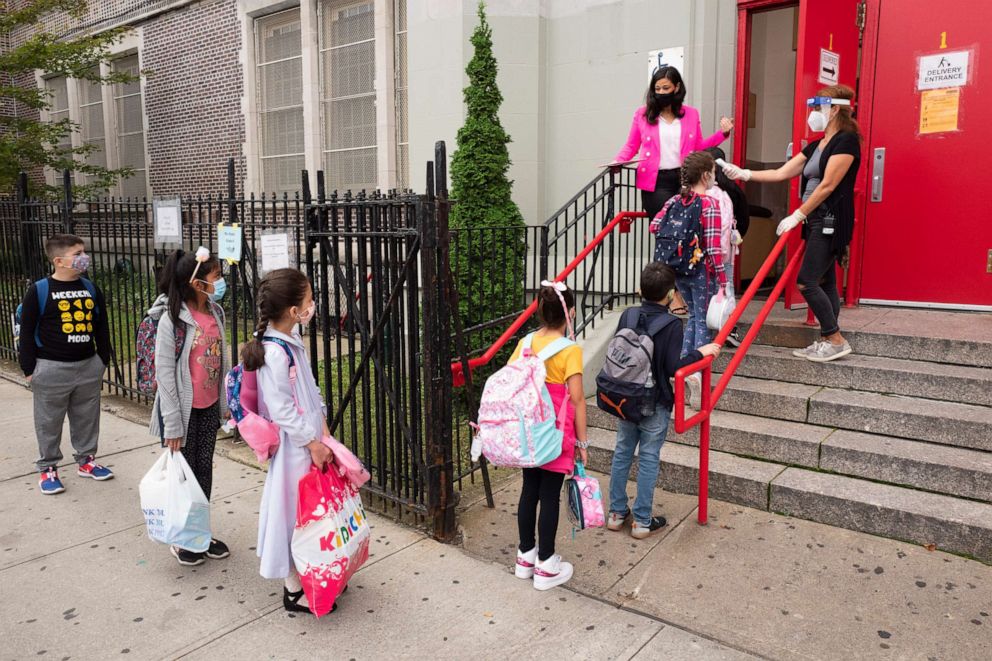PHOTO: Students line up to have their temperature checked before entering PS 179 elementary school in Brooklyn, New York, Sept. 29, 2020.