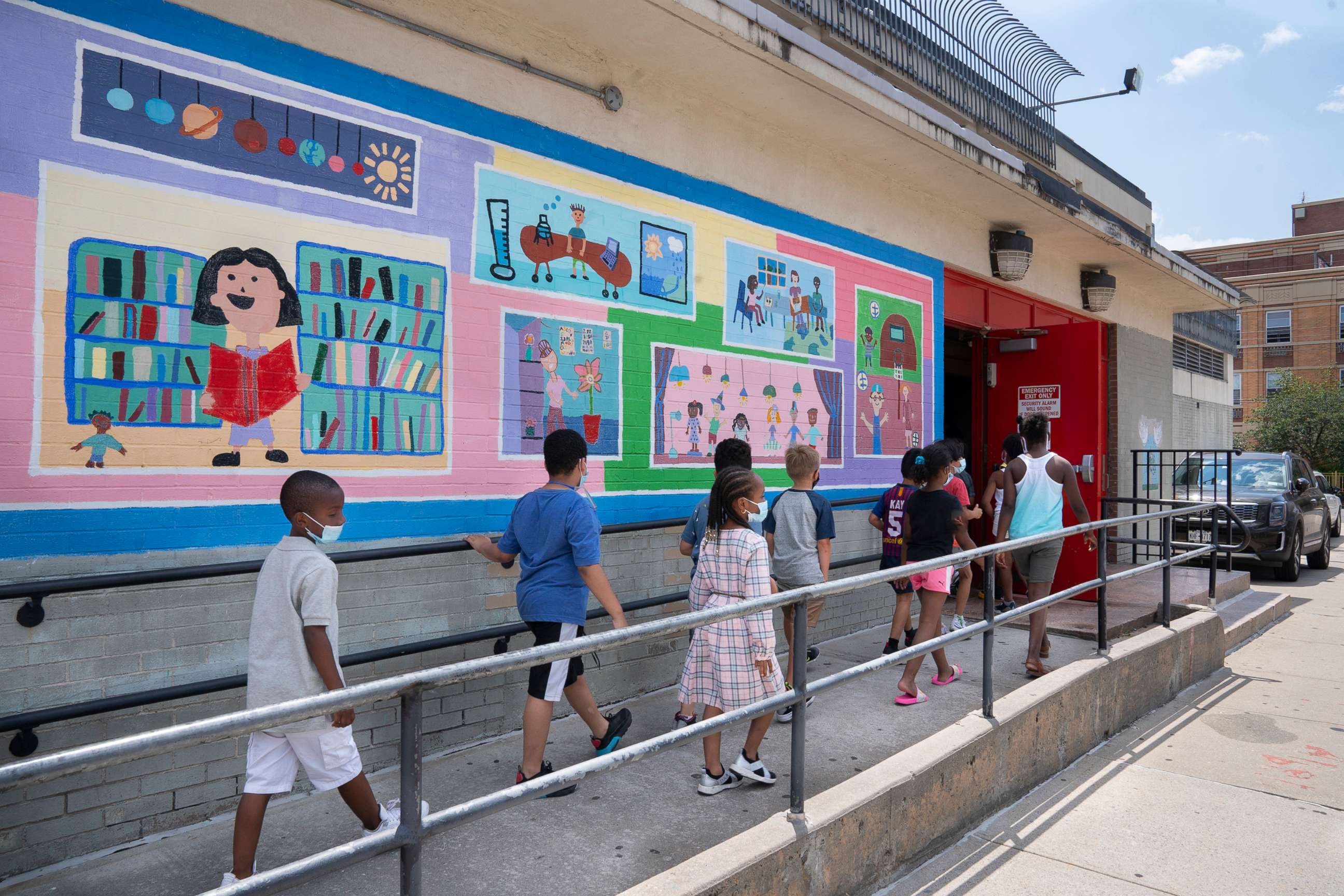 PHOTO: In this July 23, 2021, file photo, students wear masks as they enter a school in New York.