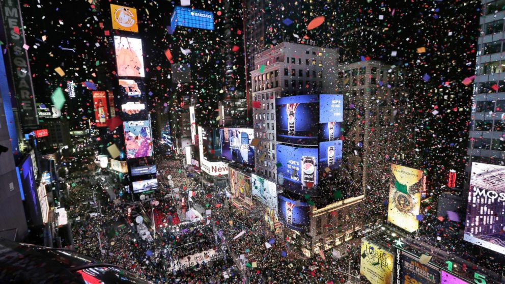 PHOTO: Confetti drops over the crowd as the clock strikes midnight during the New Year's celebration in Times Square, New York, Jan. 1, 2018. 
