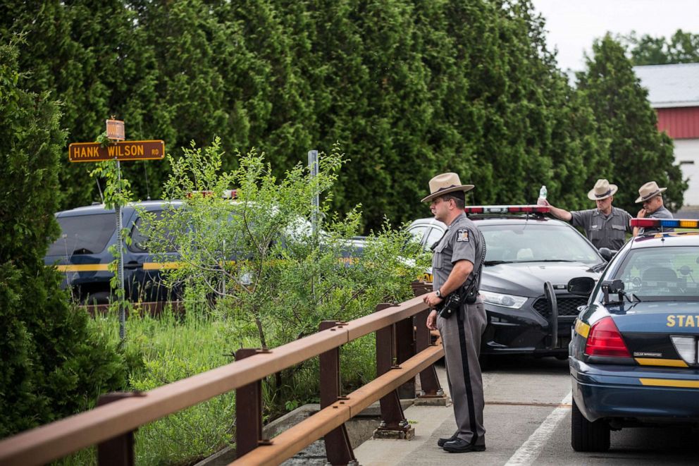 PHOTO: New York State Troopers hold a meeting while searching for two escaped convicts  on June 15, 2015, outside Dannemora, N.Y.