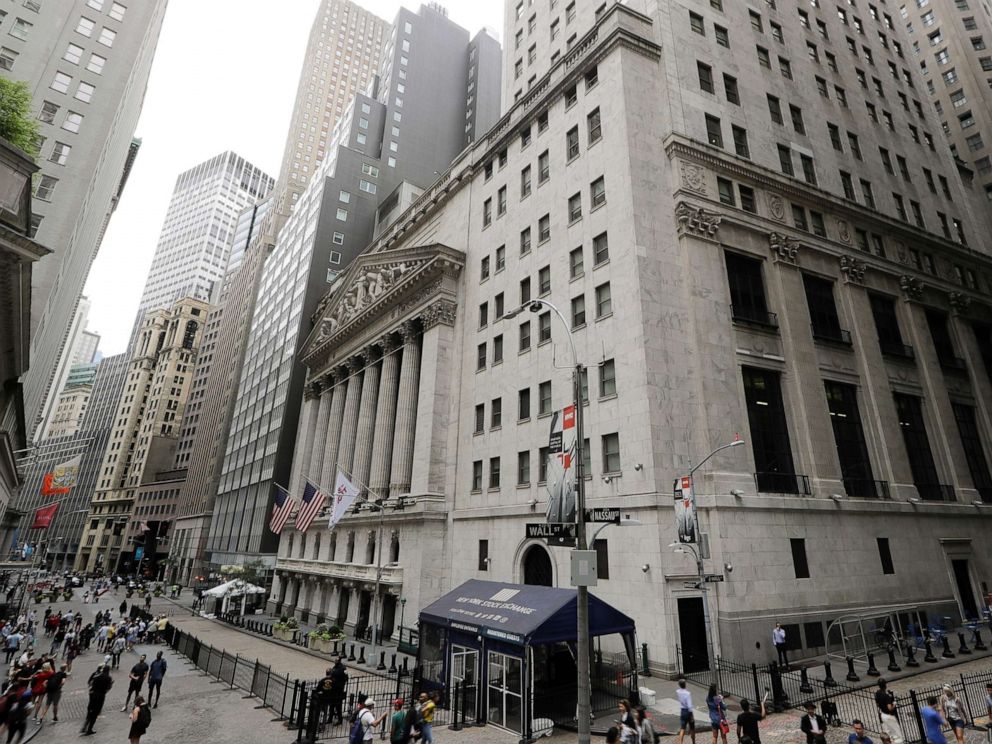 PHOTO: In this Aug. 23, 2019, file photo pedestrians pass the New York Stock Exchange in New York. 