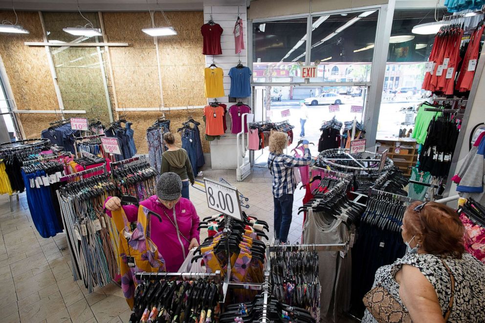 PHOTO: People shop at the Danice clothing store after it reopens, June 8, 2020, in New York.