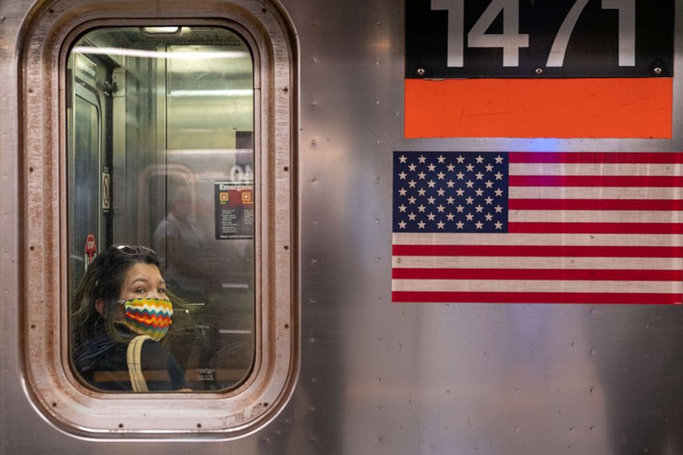 PHOTO: A person wearing a mask rides the subway during rush hour on the first day of phase one of the reopening after the coronavirus lockdown on June 8, 2020, in New York.