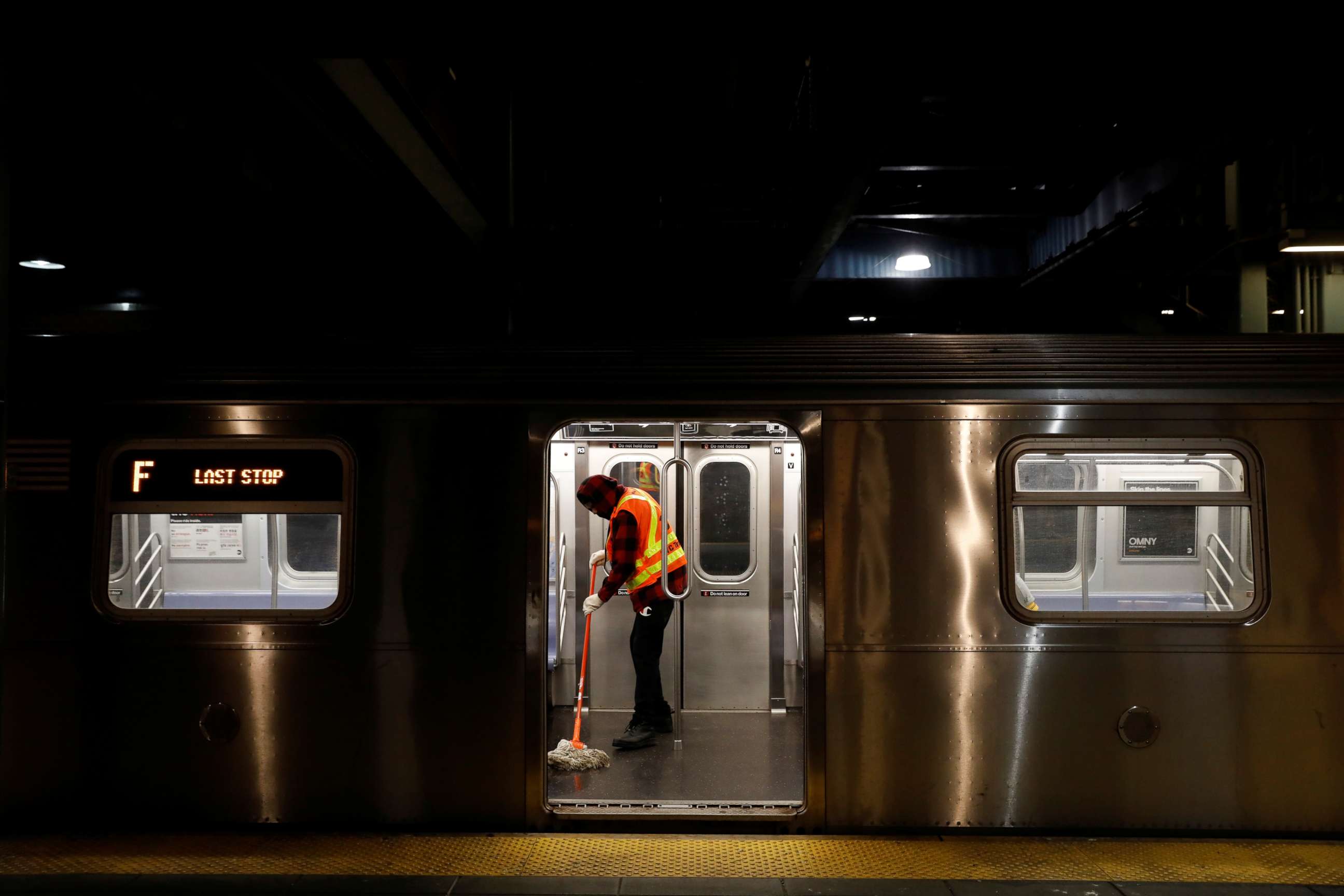 PHOTO: A worker mops the floor as the MTA Subway closed overnight for cleaning and disinfecting during the outbreak of the coronavirus disease in the Brooklyn borough of New York, May 7, 2020.