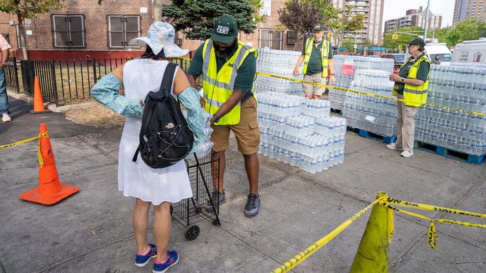 PHOTO: Residents of NYCHA Jacob Riis Houses were seen filling bottles from NYC DEP water stations or collecting bottled water at Avenue D and East 10th Street in New York, on Sept. 4, 2022.