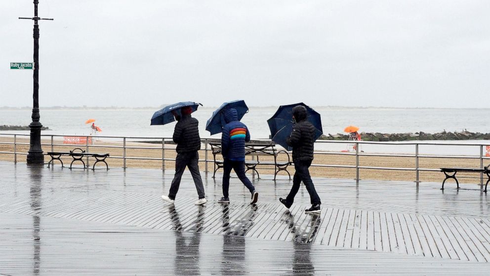 PHOTO: People walk the Coney Island boardwalk in New York City, May 29, 2021, as rain and cold weather dampen the official opening day of beaches in New York State during Memorial Day weekend.