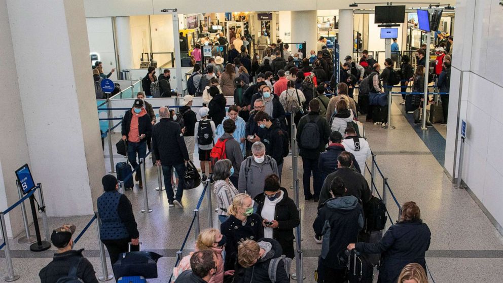 PHOTO: Passengers wait in line inside the terminal at Newark Liberty International Airport in Newark, N.J., Nov. 24, 2021.