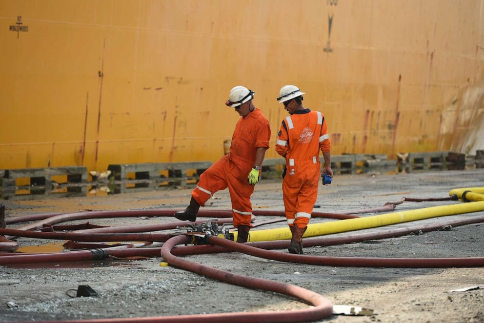 PHOTO: Firefighting teams set up hoses for dewatering and firefighting efforts on the motor vessel Grande Costa d'Avorio at Port Newark, in Newark, New Jersey, July 8, 2023.