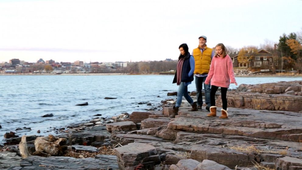 PHOTO: Alexis Hildebrand, Alan Reichard and their daughter Lydia Perrigo take a walk in Oakledge Park in Burlington, Vt.