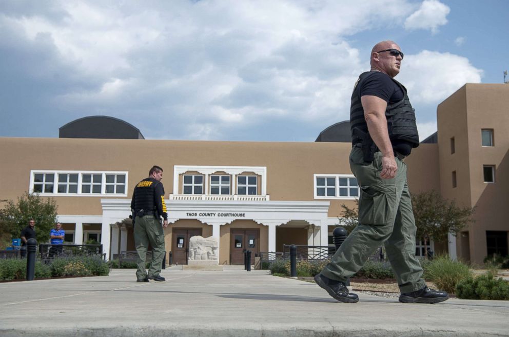 Sheriff's Officers patrol outside the Taos County Courthouse after it was closed due to security reasons. Judge Sarah Backus has received several threats since ordering the release of suspects arrested in a compound on the north side of the county.