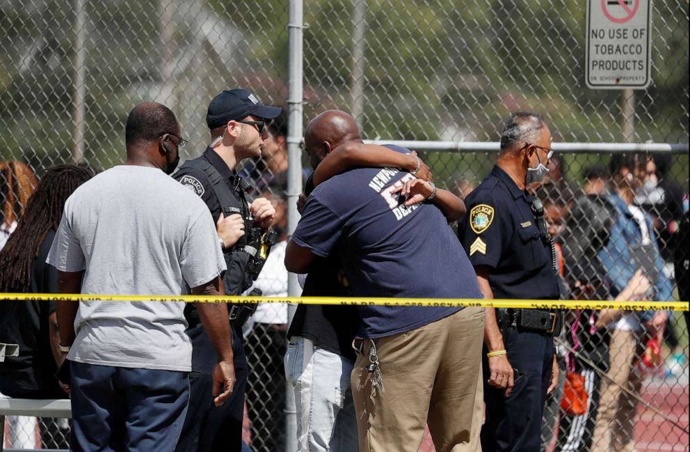 PHOTO: People embrace outside Heritage High School, Sept. 20, 2021, in Newport News, Va., following a shooting incident.