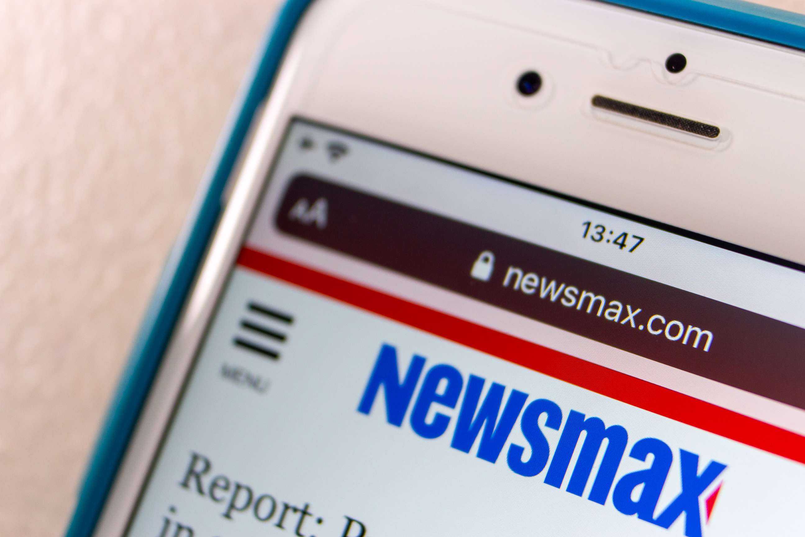 PHOTO: The Newsmax logo is seen on an iPhone screen in Kumamoto, Japan, Mar 12, 2021.