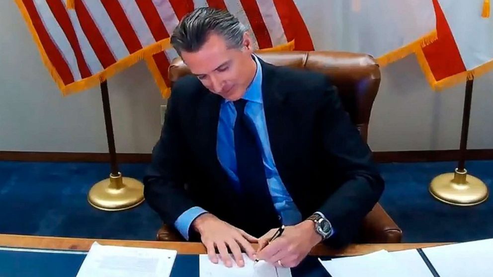 PHOTO: California Gov. Gavin Newsom signs into law a bill that establishes a task force to come up with recommendations on how to give reparations to Black Americans on Sept. 30, 2020, in Sacramento, Calif.
