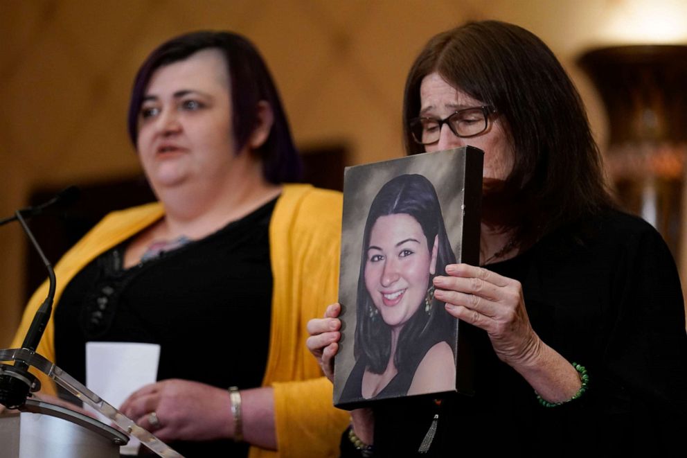 PHOTO: While Hannah D'Avino, left, speaks, Mary D'Avino holds up a picture of her daughter Rachel D'Avino, who was killed during the Newtown shooting, during a news conference in Trumbull, Conn., Feb. 15, 2022.