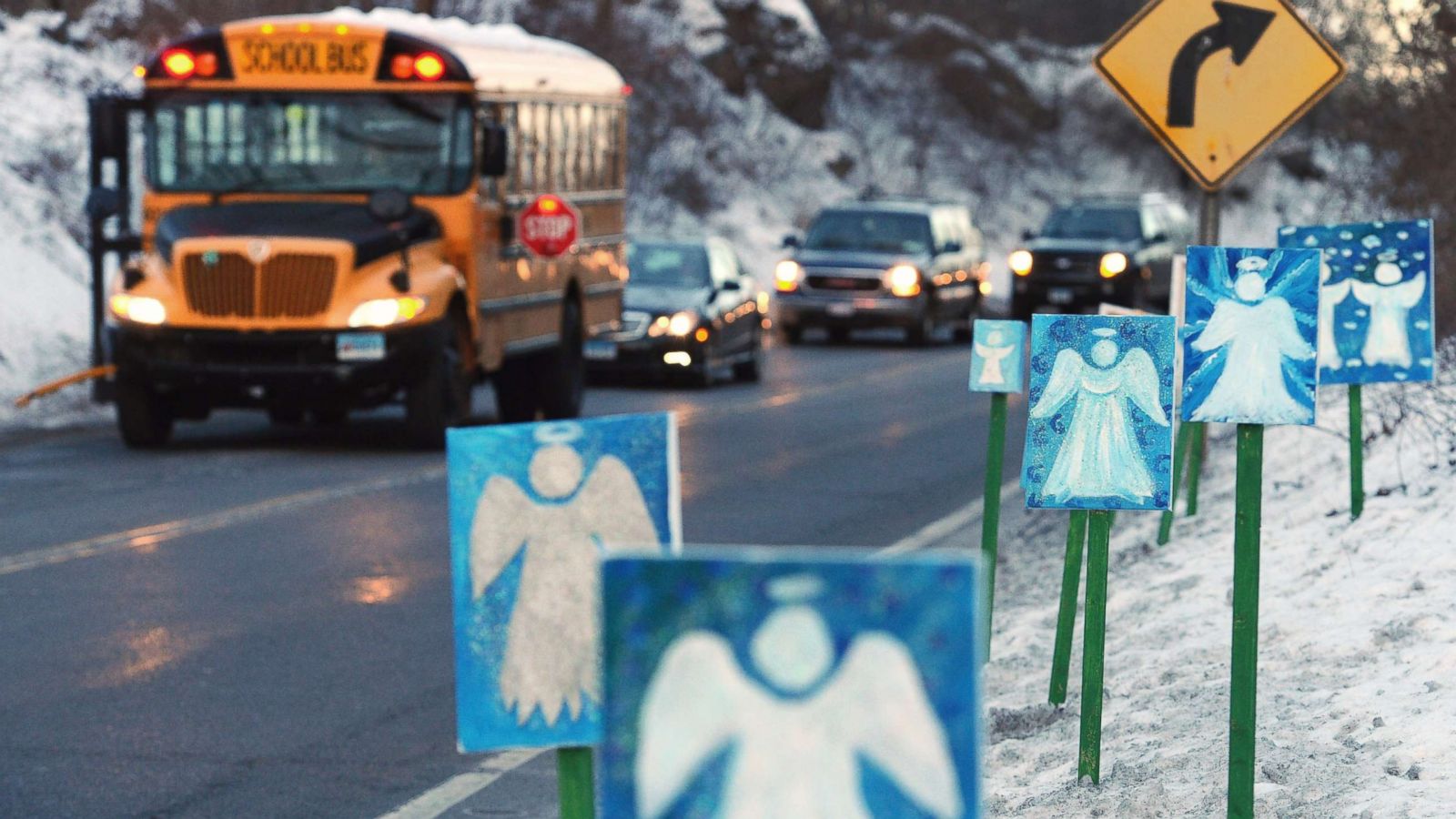 PHOTO: A bus traveling from Newtown to Monroe, Conn., stops in front of 26 angels along the roadside on the first day of classes for Sandy Hook Elementary School students since the Dec. 14, 2012 shooting.