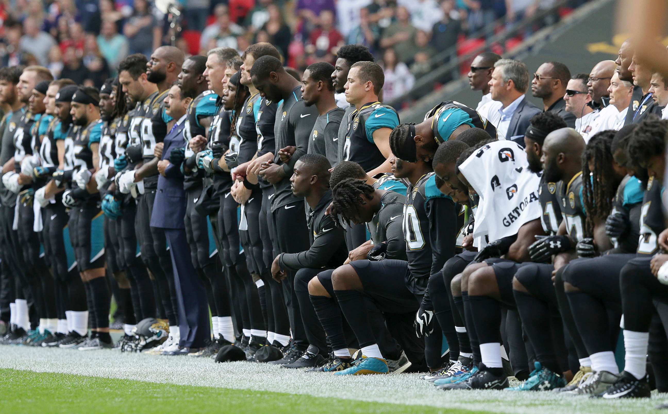 PHOTO: Jacksonville Jaguars NFL football players are shown, some standing and some kneeling, during the playing of the national anthem at Wembley Stadium in London.