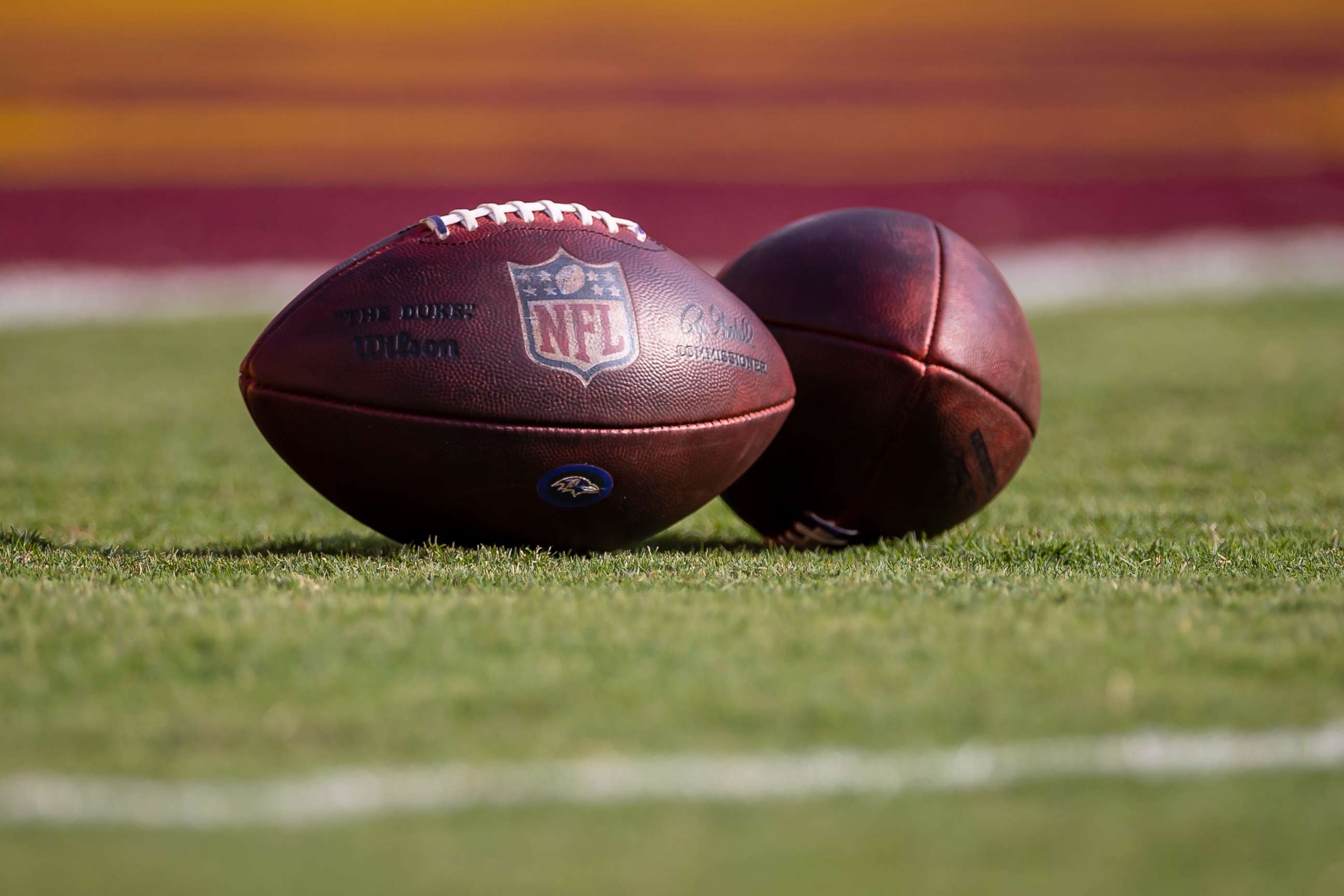 PHOTO: Two NFL footballs on the field before the preseason game between the Washington Football Team and the Baltimore Ravens, Aug. 28, 2021 in Landover, Maryland.