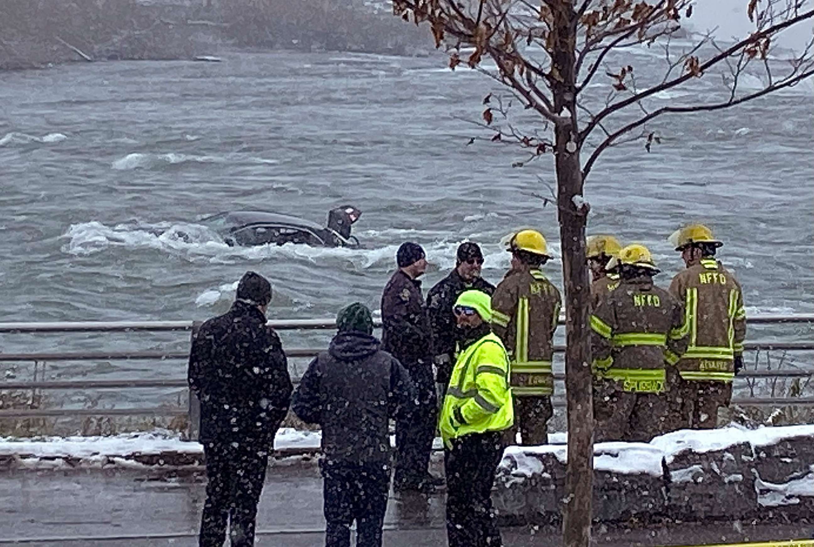 PHOTO: First responders monitor a car partially submerged in the Niagara River near the brink of American Falls, Wednesday, Dec. 8, 2021, in Niagara Falls, N.Y. 