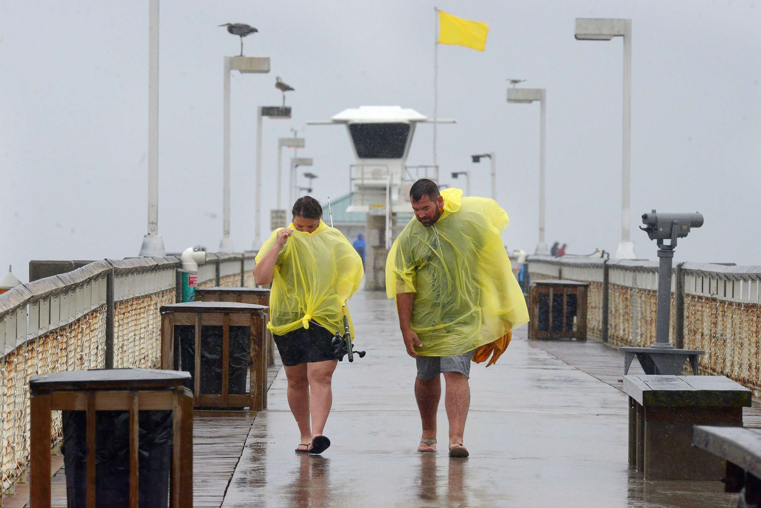 PHOTO: People use ponchos to stay dry as thei walk along the Okaloosa Island Fishing Pier on Sept. 15, 2021 in Ft. Walton, Fla. Heavy rains from Tropical Depression Nicholas continues as Tropical Storm Nicholas makes its way across Texas and Louisiana.