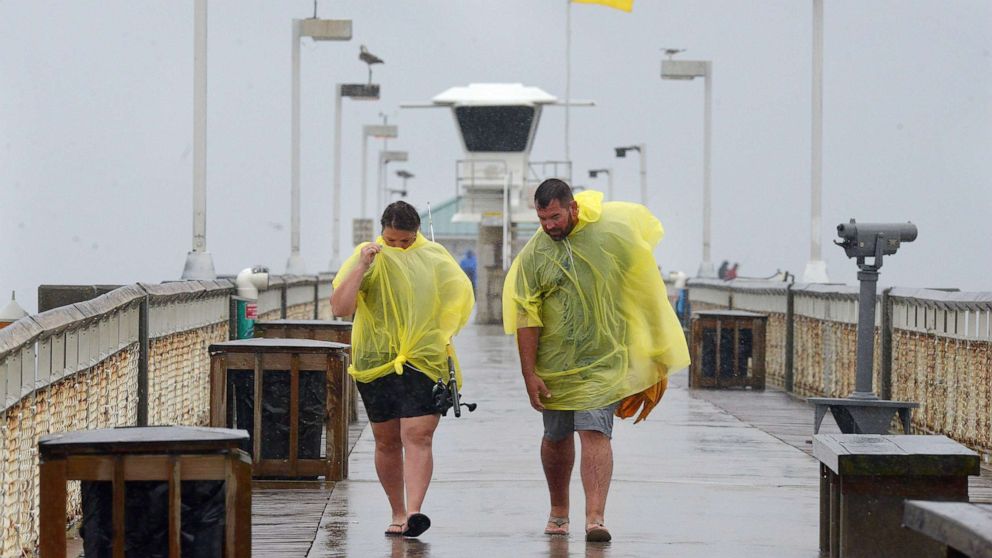 PHOTO: People use ponchos to stay dry as thei walk along the Okaloosa Island Fishing Pier on Sept. 15, 2021 in Ft. Walton, Fla. Heavy rains from Tropical Depression Nicholas continues as Tropical Storm Nicholas makes its way across Texas and Louisiana.