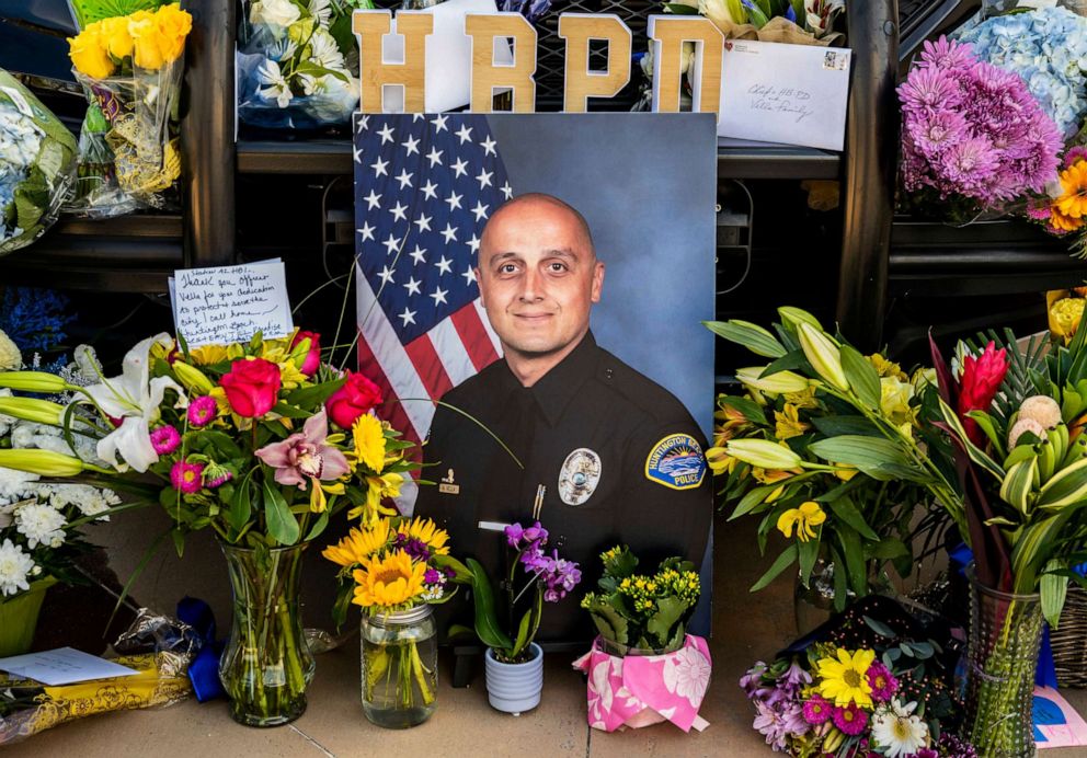 PHOTO: A photo of Huntington Beach police officer Nicholas Vella is displayed alongside flowers and notes as part of a memorial outside the Huntington Beach Police Department in Huntington Beach, Calif., Feb. 20, 2022.