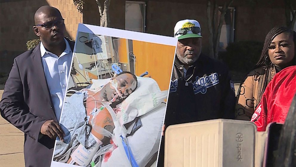 PHOTO: Tyre Nichols' stepfather Rodney Wells, center right, stands next to a photo of Nichols in the hospital after his arrest, during a protest in Memphis, Tenn., Jan. 14, 2023.