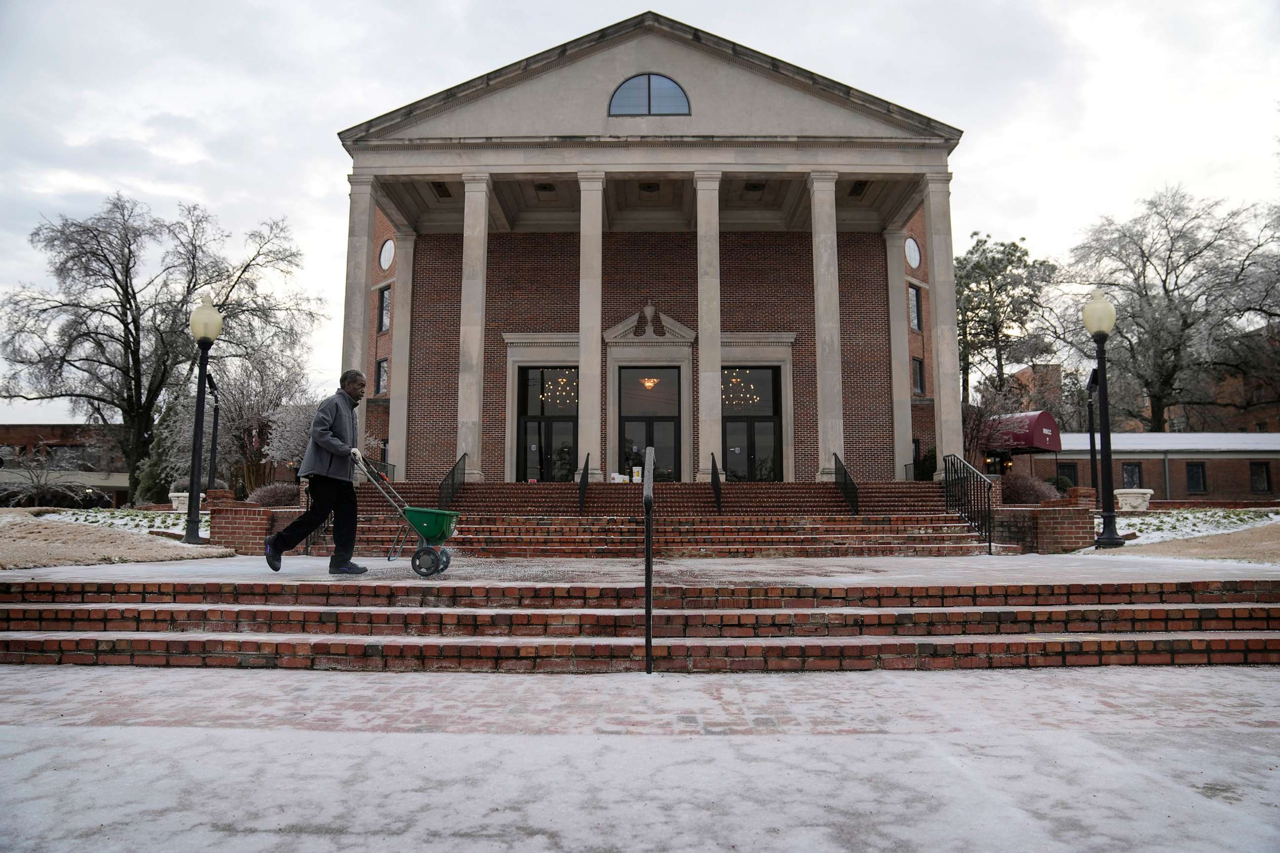 PHOTO: Terry Lawrence spreads ice melting salt around Mississippi Boulevard Christian Church where a funeral service for Tyre Nichols will be held, Feb. 1, 2023, in Memphis, Tenn.