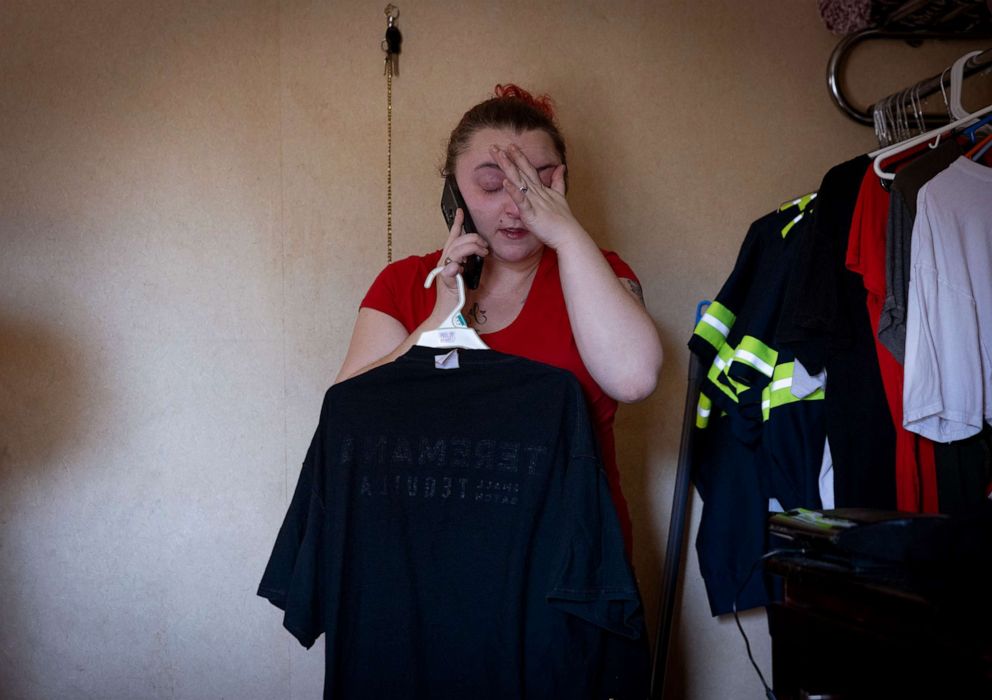 PHOTO: Nicki Schools cries while taking a phone call from an old friend who is struggling with addiction, Jan. 22, 2022, at the motel where she is living, in Richmond, Va.