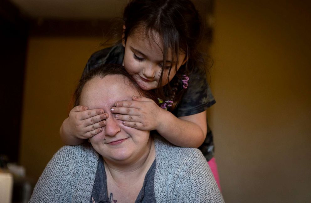 PHOTO: Nicki Schools plays with her daughter NyAnna in their motel room, Jan. 10, 2022, in Richmond, Va.