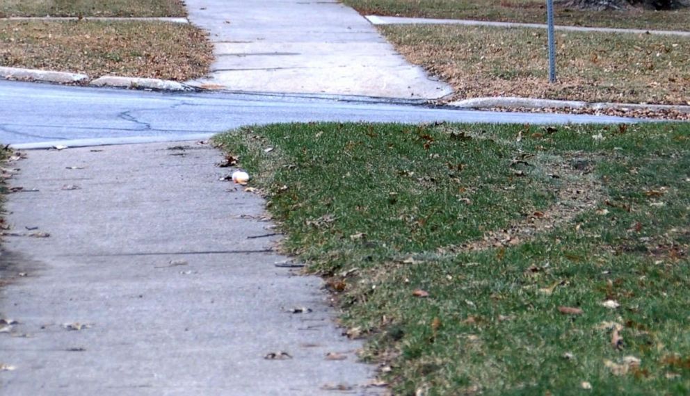 PHOTO: Tire tracks are visible on grass after a woman identified by police as Nicole Poole allegedly ran over a 14-year-old Latino girl who was walking to school in Clive, Iowa, Dec. 9, 2019.