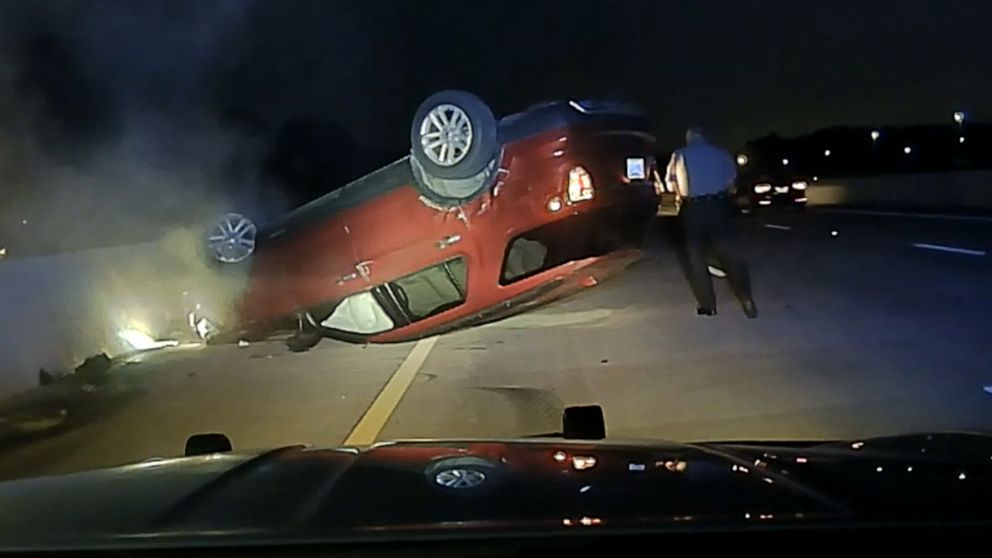 PHOTO: A trooper walks around Janice Nicole Harper's overturned car on U.S. Highway 167 in Pulaski County, Ark., on July 9, 2020, in police dash cam footage provided to ABC News by attorney Andrew Norwood.