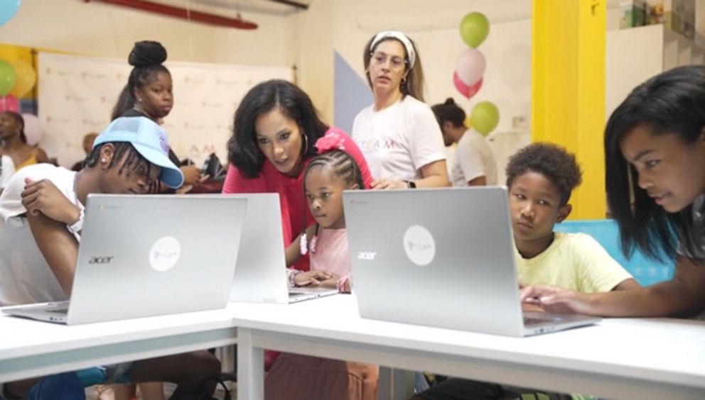 PHOTO: Founder and CEO of S.T.E.A.M. Champs Niesha Butler is seen working 1 on 1 with students during a workshop session.