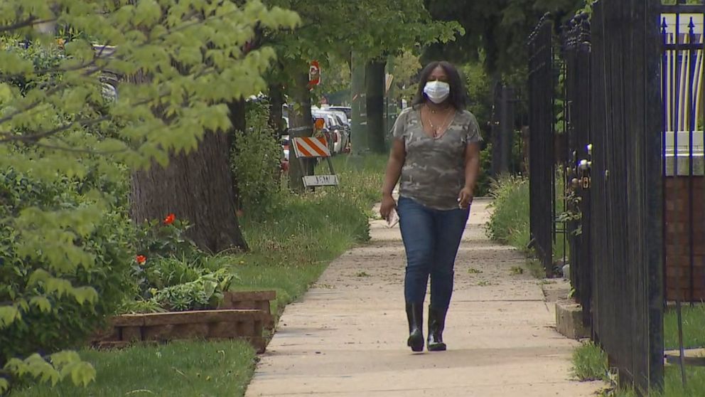 PHOTO: Nakiea Love walks down the street outside her home in Chicago's Auburn Gresham neighborhood.
