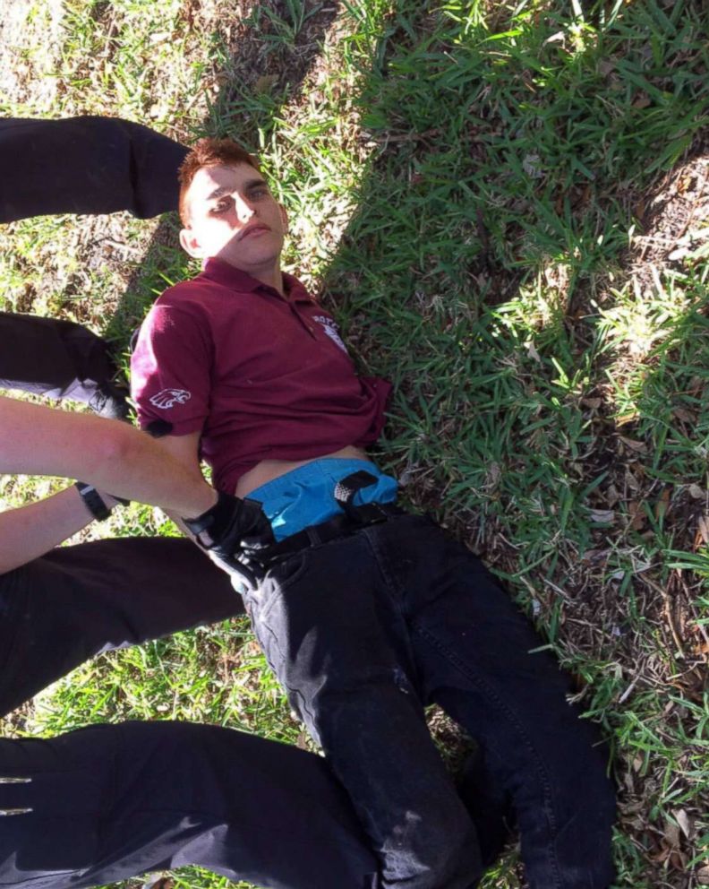 PHOTO: Nikolas Cruz is placed into handcuffs by police near Marjory Stoneman Douglas High School following a mass shooting in Parkland, Fla., Feb. 14, 2018.