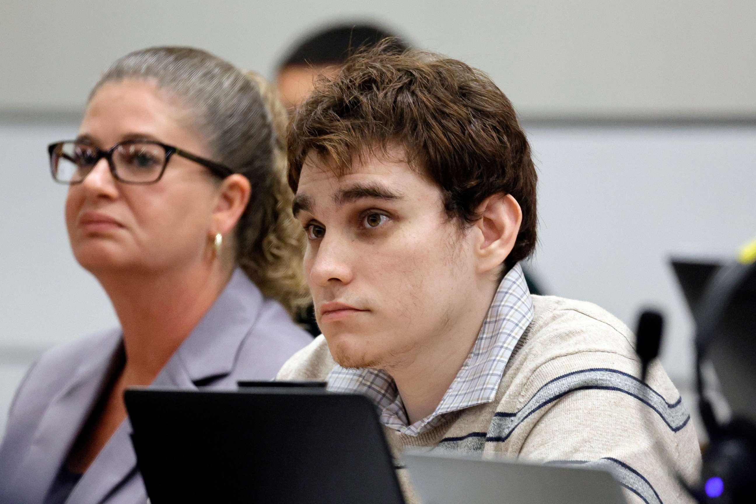 PHOTO: Marjory Stoneman Douglas High School shooter Nikolas Cruz looks up at his attorney as she gives her closing argument in the penalty phase of Cruz's trial at the Broward County Courthouse in Fort Lauderdale, Fla., Oct. 11, 2022.
