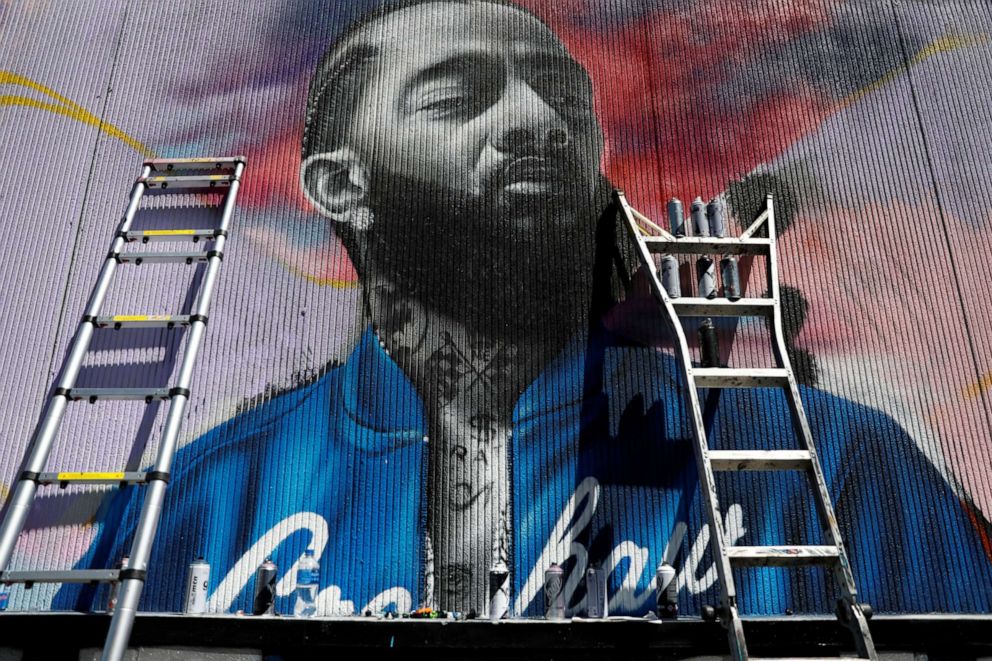 PHOTO: A mural is pictured as people mourn the shooting death of musician Nipsey Hussle outside of his The Marathon Clothing store on Slauson Avenue in Los Angeles, April 7, 2019.