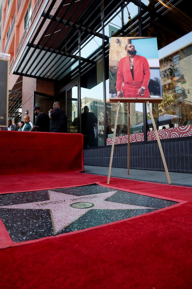 PHOTO: 	
A portrait of late Nipsey Hussle sits next to his star during its unveiling as he is honored posthumously on the Hollywood Walk of Fame in Los Angeles, August 15, 2022. 
