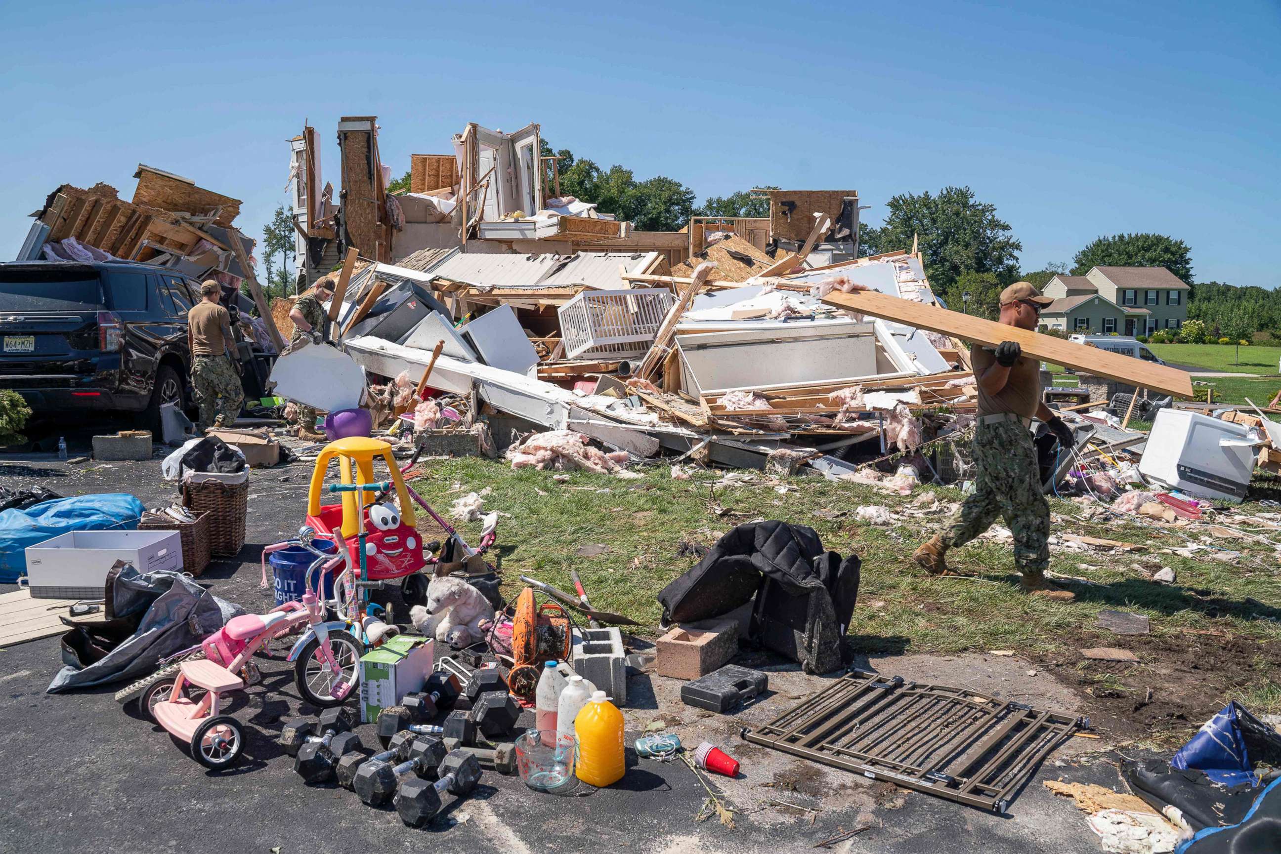 PHOTO: A group of Navy recruiters based in Philadelphia clear debris from the house of Ashley Thomas which was destroyed by a tornado in Mullica Hill, N.J., Sept. 2, 2021.