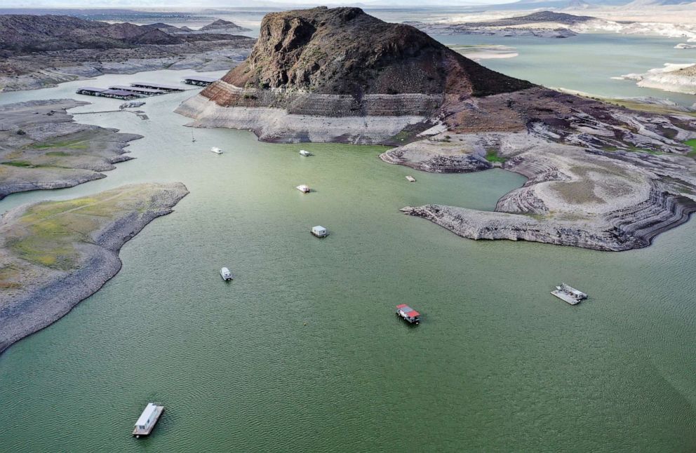 PHOTO: An aerial view of boats anchored near a "bathtub ring" of mineral deposits left by higher water levels at the drought-stricken Elephant Butte Reservoir on Aug. 16, 2022, near Truth or Consequences, N.M.