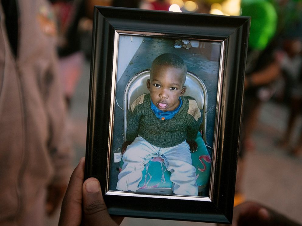 PHOTO: A photo of Noah Sneed is held during a gathering to honor his life with a candlelight memorial in front of the Ceressas Enrichment and Empowerment Academy in Oakland Park, Fla., July 30, 2019.