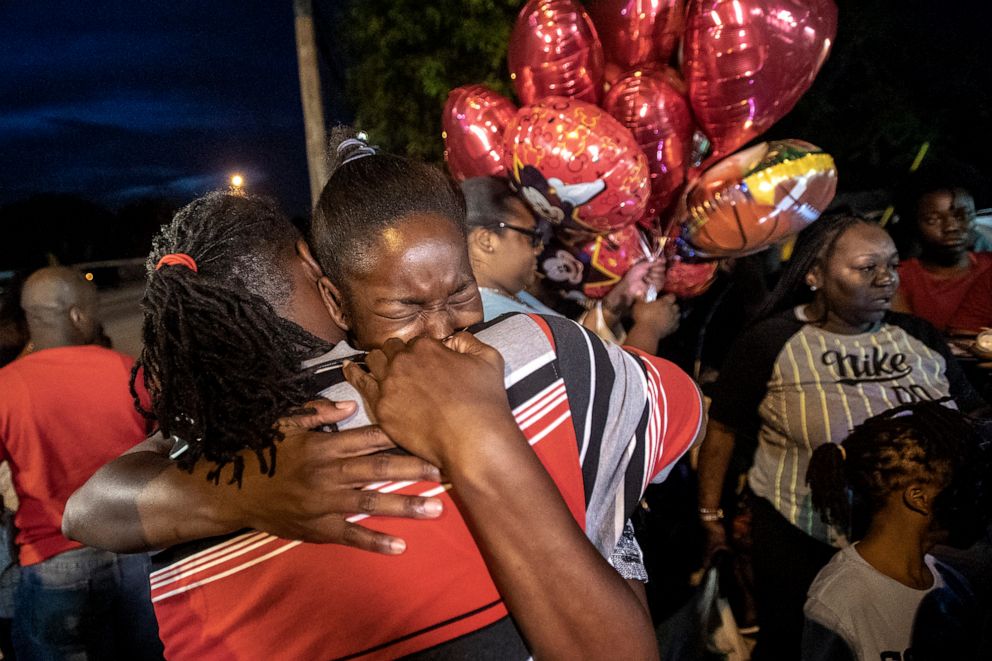 PHOTO: Chanese Sneed, the mother of Noah Sneed hugs Noah's father Tony Bell during a gathering to honor his life with a candlelight memorial in front of the Ceressa's Daycare & Preschool Center, July 30, 2019, in Oakland Park, Fla.