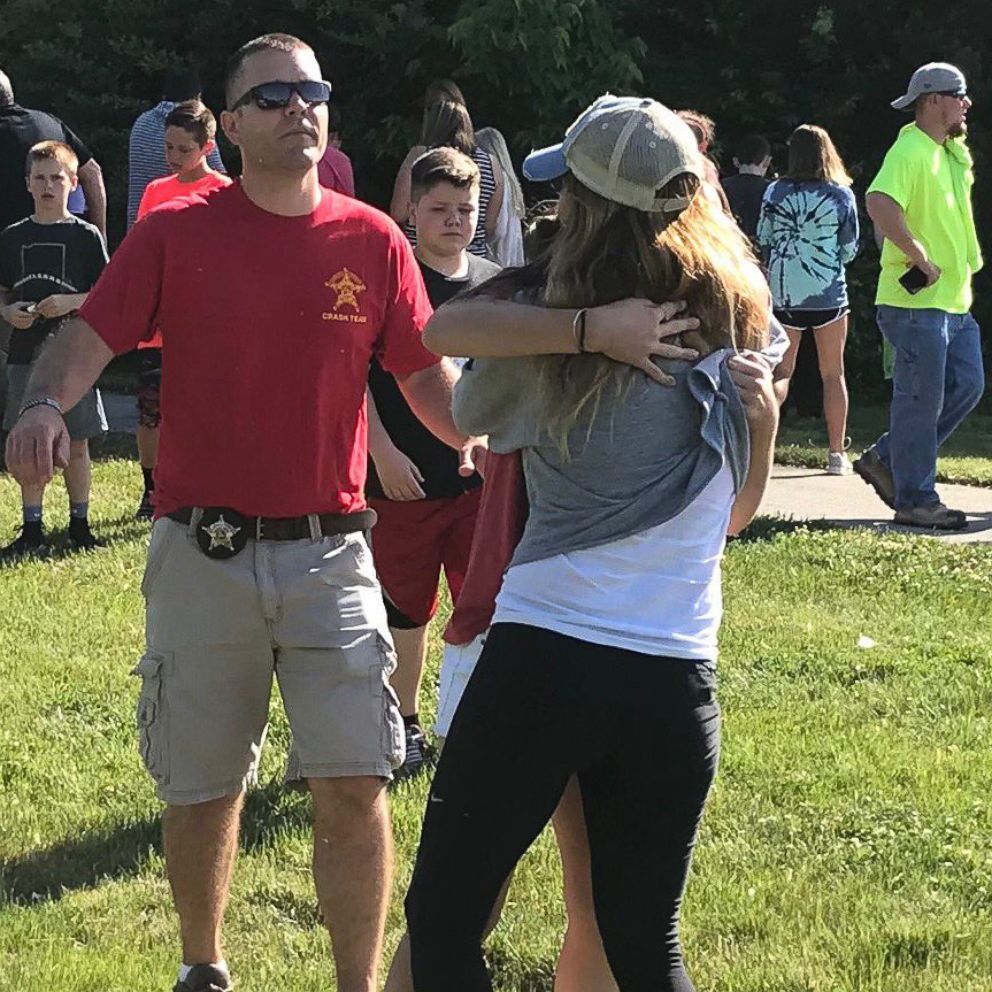 PHOTO: People hug after a shooting at Noblesville West Middle Scholl in Noblesville, Ind., May 25, 2018.